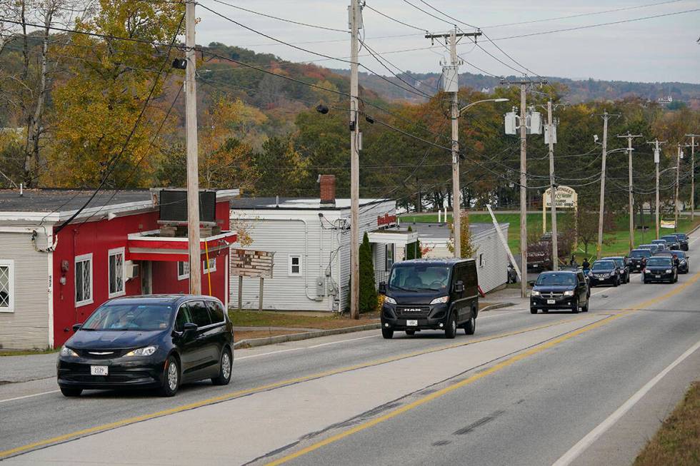 Three vehicles transport bodies from Schemengees Bar and Grille, Thursday, Oct. 26, 2023, in Le ...