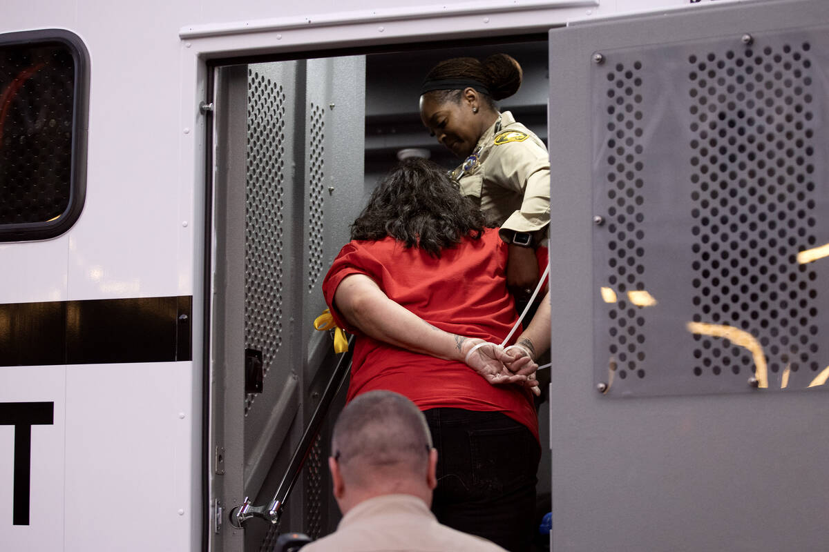 A culinary union member is loaded onto a transport bus after being arrested for blocking traffi ...