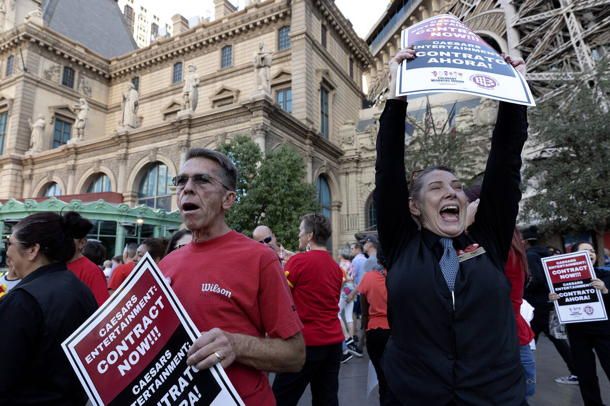 Jimmy Tyner, left, and Faye Warrick, right, join thousands of culinary union members as they pr ...