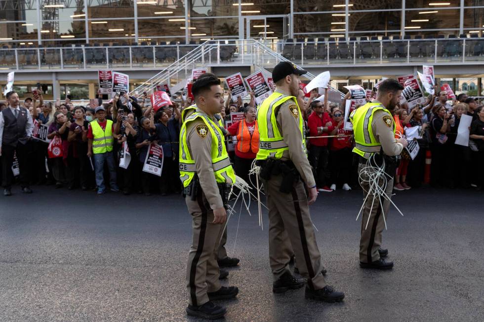 Metropolitan police prepare to arrest culinary union members for blocking traffic during a rall ...