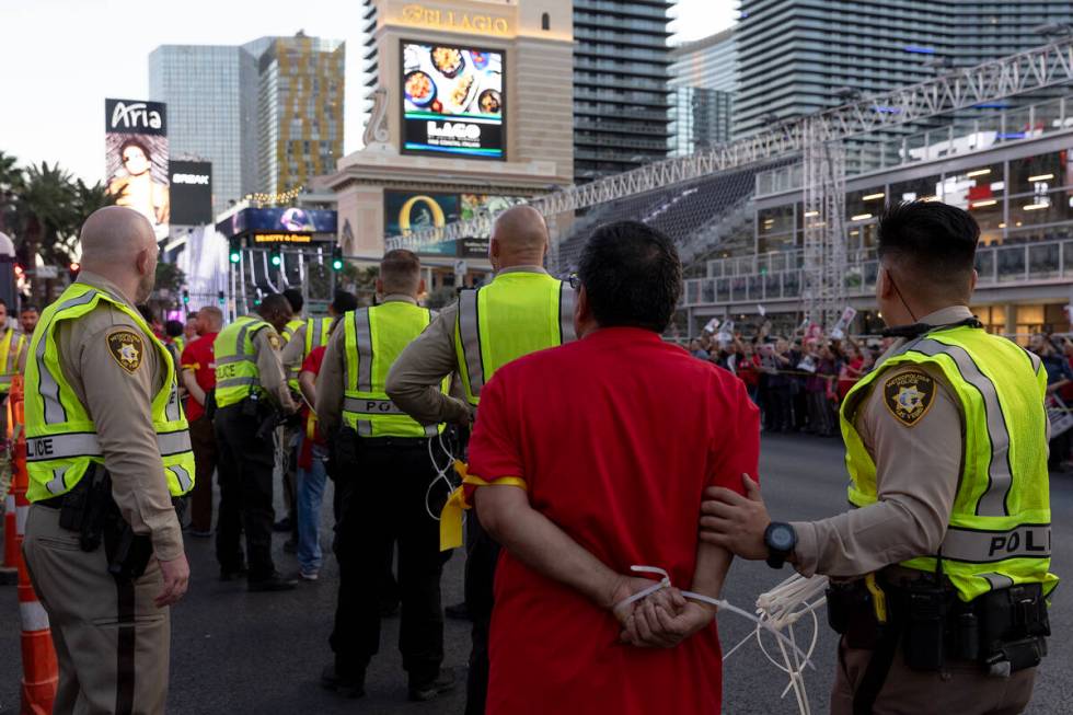 Metropolitan police arrest culinary union members as they protest along Las Vegas Boulevard on ...