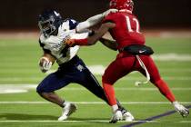 Shadow Ridge running back Trevin Young (4) runs through an attempted tackle by Arbor View&#x201 ...