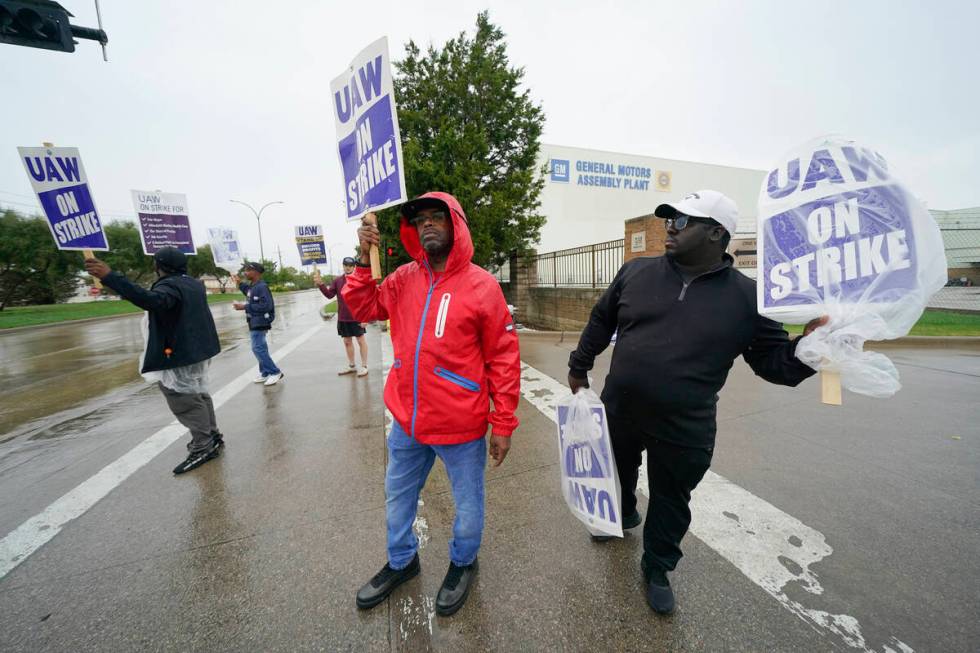 File - Picketers strike outside of the General Motors assembly plant, Tuesday, Oct. 24, 2023, i ...