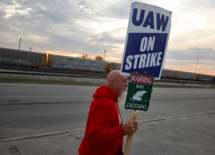 File - Dan Back, a United Auto Workers Local 12 member, pickets during the ongoing UAW strike a ...