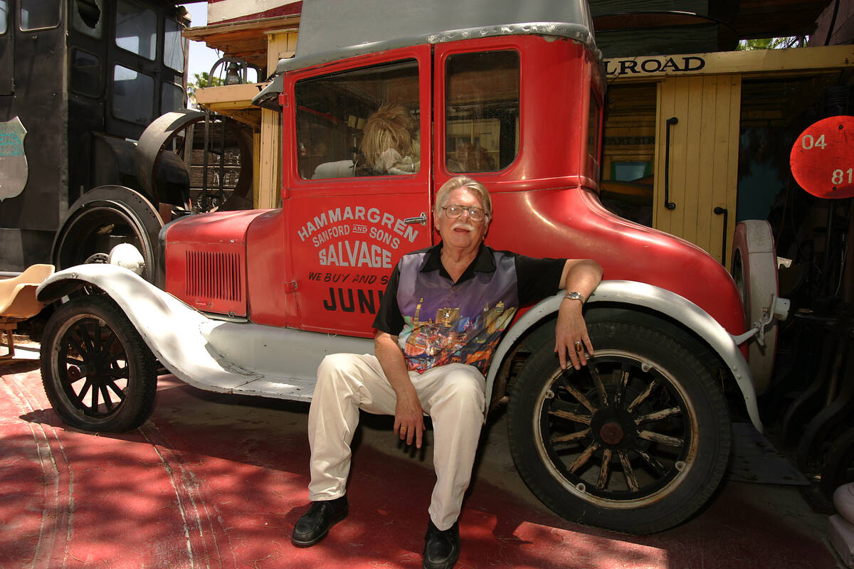 Lonnie Hammargren sits in his backyard on the step of a vintage car that once belonged to actor ...