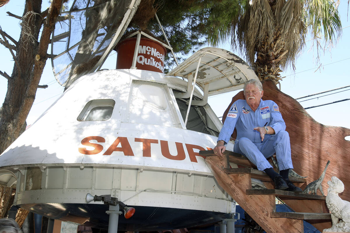 Lonnie Hammargren sit next to a space capsule mockup in his backyard on July 17, 2009, in Las V ...