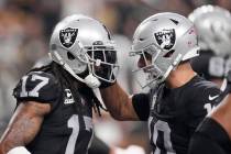 Las Vegas Raiders wide receiver Davante Adams (17) celebrates with quarterback Jimmy Garoppolo ...