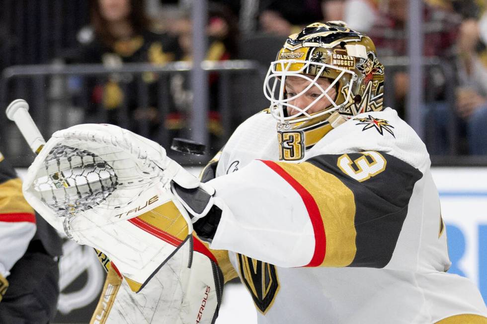 Golden Knights goaltender Adin Hill (33) saves the puck during the second period of an NHL hock ...