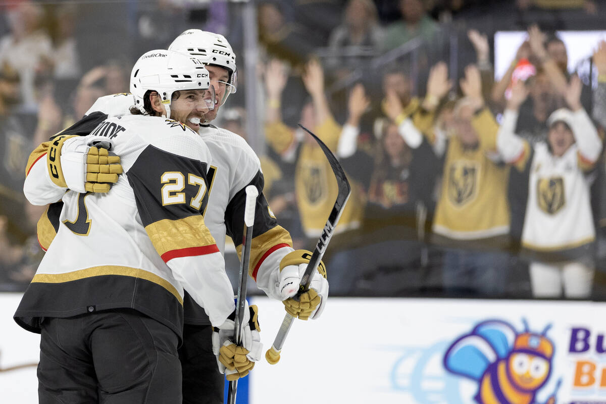 Golden Knights defenseman Shea Theodore (27) celebrates his goal with defenseman Brayden McNabb ...