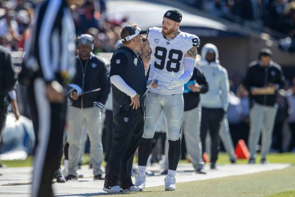 Raiders defensive end Maxx Crosby (98) has engages in an animated discussion with Raiders head ...