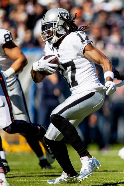 Raiders wide receiver Davante Adams (17) runs after making a catch during the first half of an ...