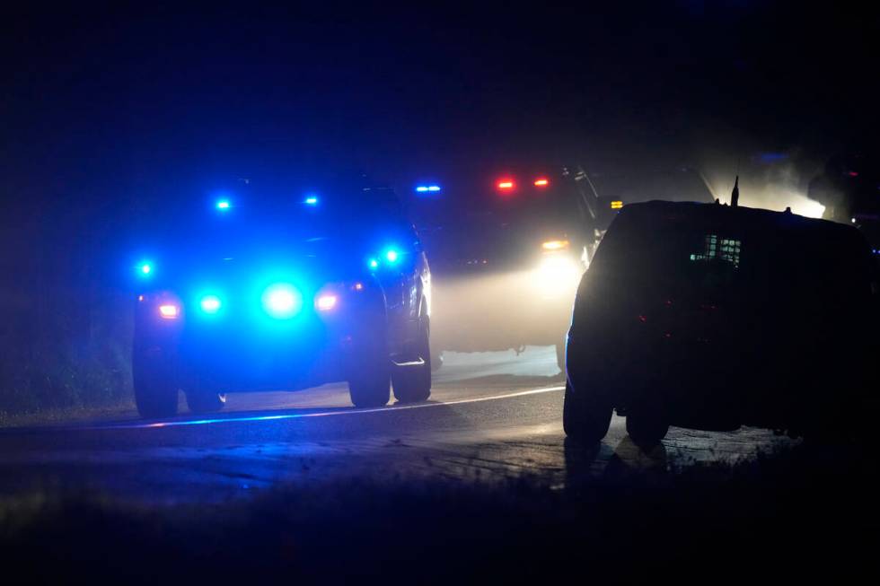 Law enforcement vehicles depart a scene at a property on Meadow Road, in Bowdoin, Maine, Thursd ...