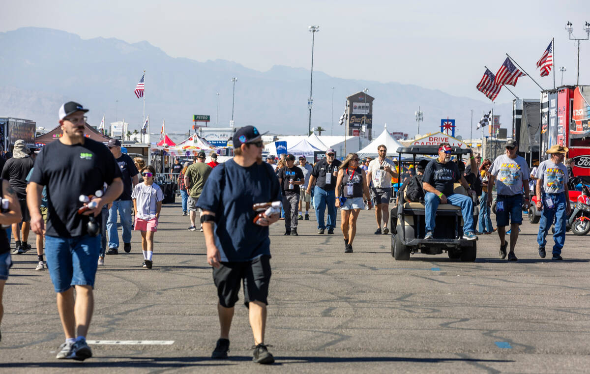 Fans walk about a midway during a qualifying session in the NHRA Nevada Nationals at The Strip ...
