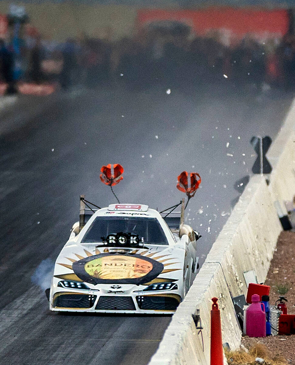 Funny Car driver Alexis DeJoria chips up paint off the cement barricades as she gets too close ...