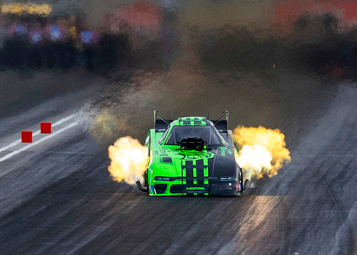 Funny Car racer Matt Hagan blasts down the track during a qualifying session in the NHRA Nevada ...