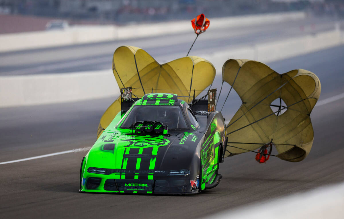 Funny Car racer Matt Hagan replays his parachutes during a qualifying session in the NHRA Nevad ...