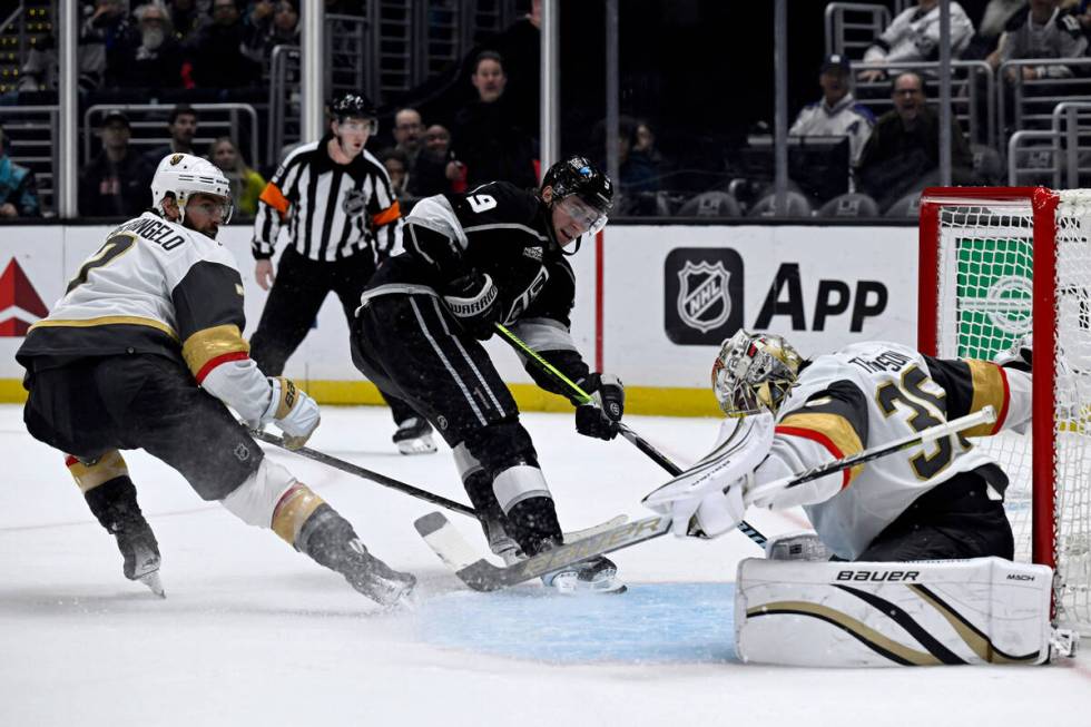 Vegas Golden Knights goaltender Logan Thompson, right, blocks a shot by Los Angeles Kings cente ...