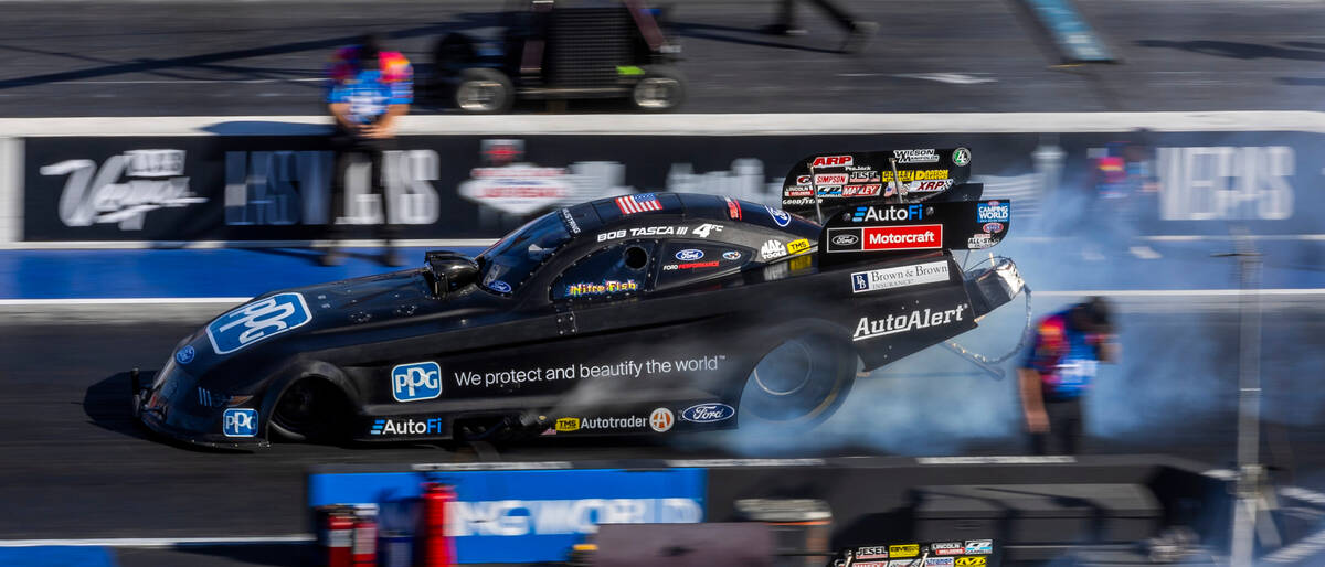 Bob Tasca III burns his tires during a Funny Car qualifying session in the NHRA Nevada National ...