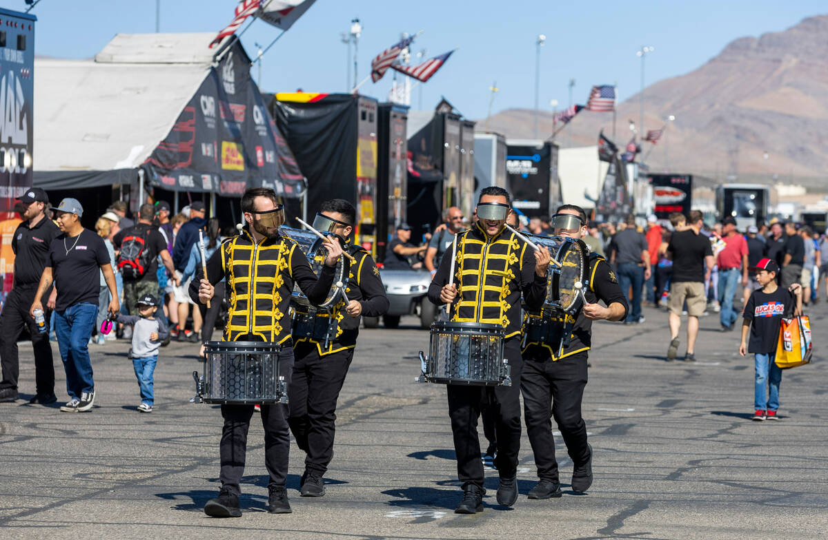 Members of The Drumbots, the official Drum Line of the Golden Knights, play along the midway du ...