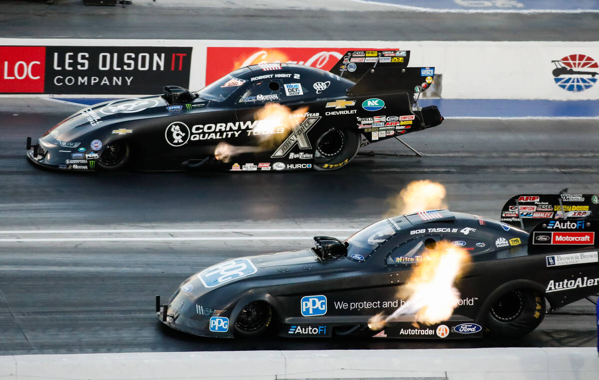 Robert Hight, top, takes the lead against Bob Tasca III moments before winning the nitro elimin ...