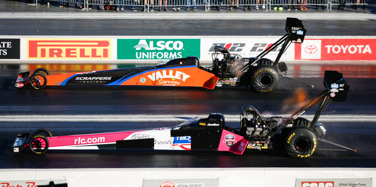 Mike Salinas, top, takes on Josh Hart during the nitro eliminations top fuel semifinals race at ...