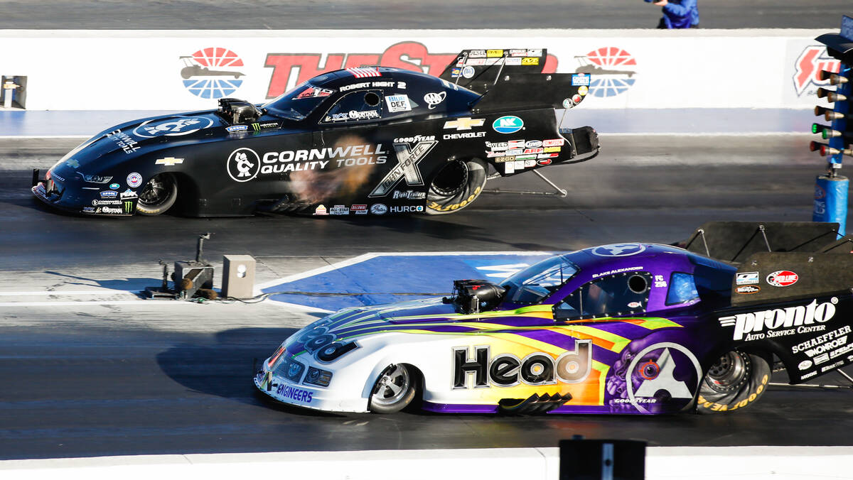 Robert Hight, top, and Blake Alexander go head to head during the nitro eliminations funny car ...