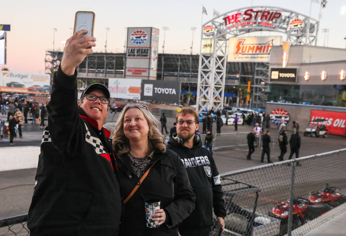 Michael Ash, left, Holly Ash, and Dalton Weiss, all from Montana, take a selfie at the NHRA Nev ...