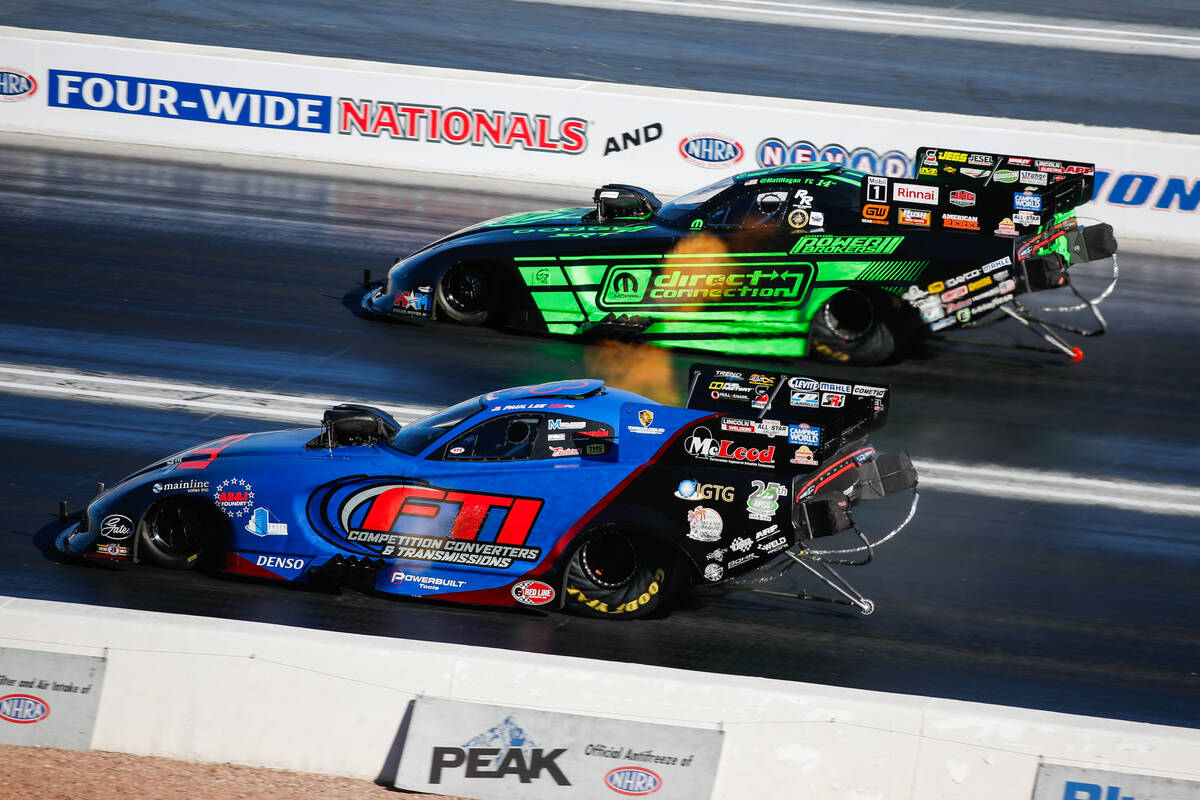 Matt Hagan, top, and Paul Lee go head to head during round 2 of the funny car nitro elimination ...