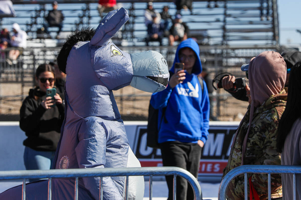 People take pictures of someone in a donkey costume at the NHRA Nevada Nationals at The Strip a ...
