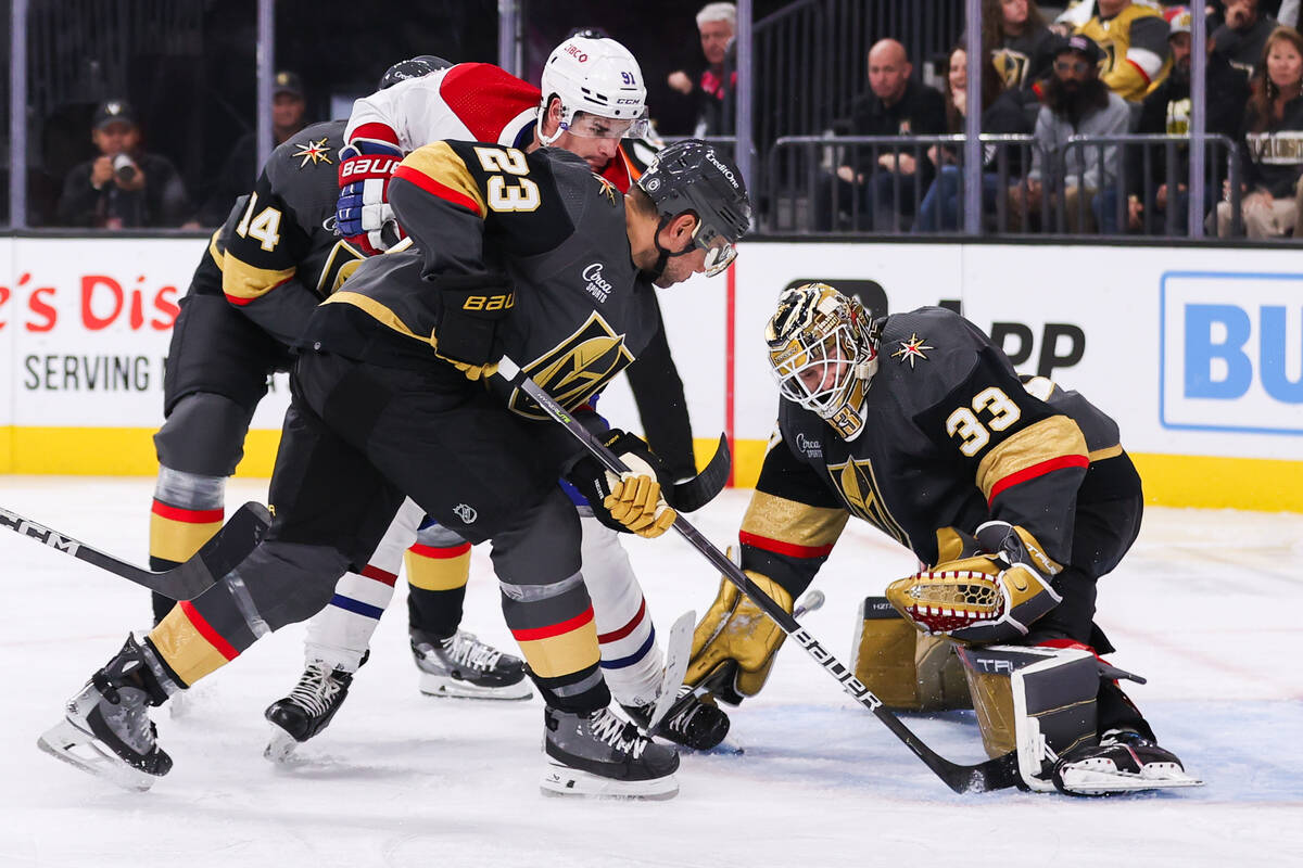 Golden Knights goaltender Adin Hill (33) and Golden Knights defenseman Alec Martinez (23) block ...