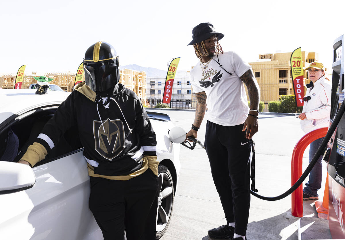 Vegas Golden Knights fan Travis Bradley, left, shows his support for his team by wearing the te ...