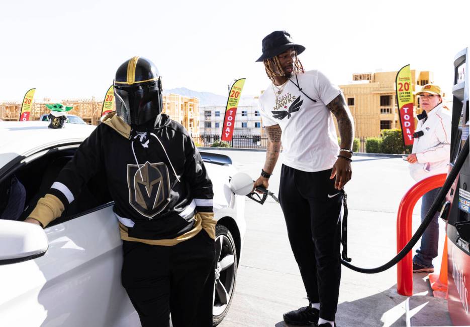 Vegas Golden Knights fan Travis Bradley, left, shows his support for his team by wearing the te ...