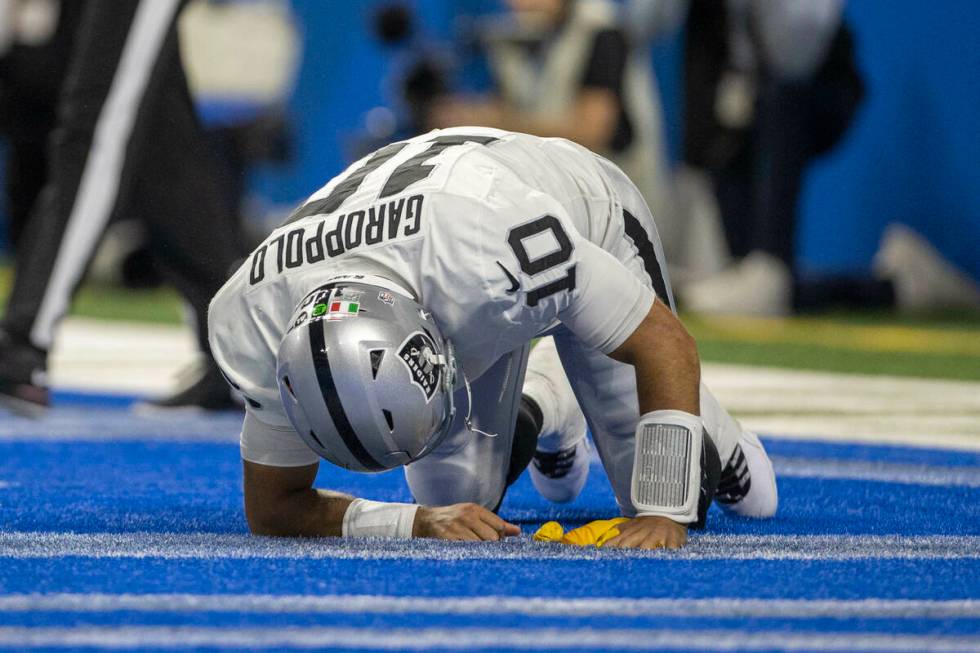 Raiders quarterback Jimmy Garoppolo (10) remains down after being hit with a flag thrown for un ...