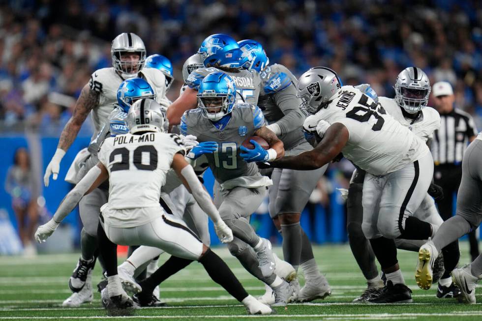 Detroit Lions running back Craig Reynolds (13) rushes during the first half of an NFL football ...