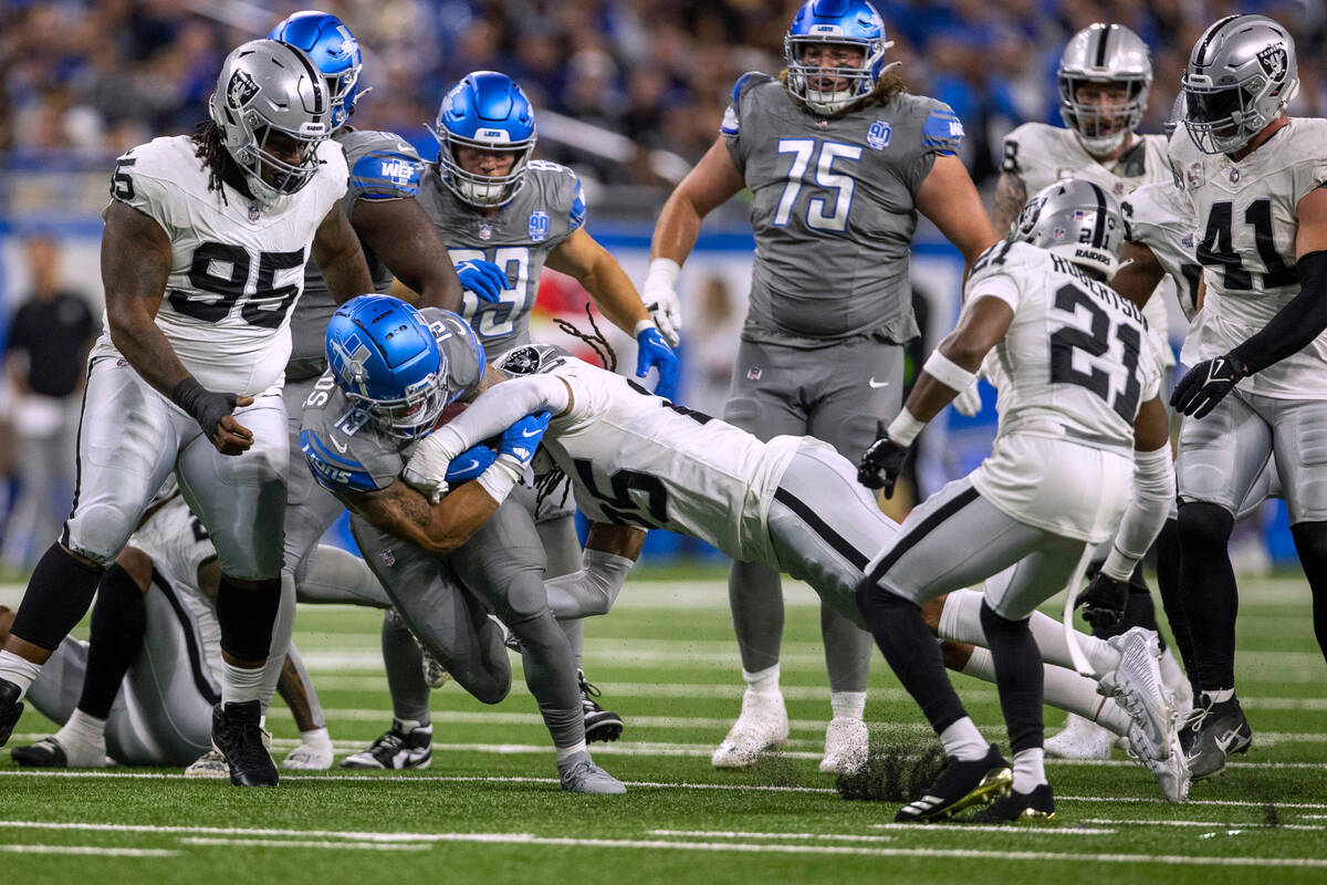 Raiders safety Tre'von Moehrig (25) tackles Detroit Lions running back Craig Reynolds (13) duri ...