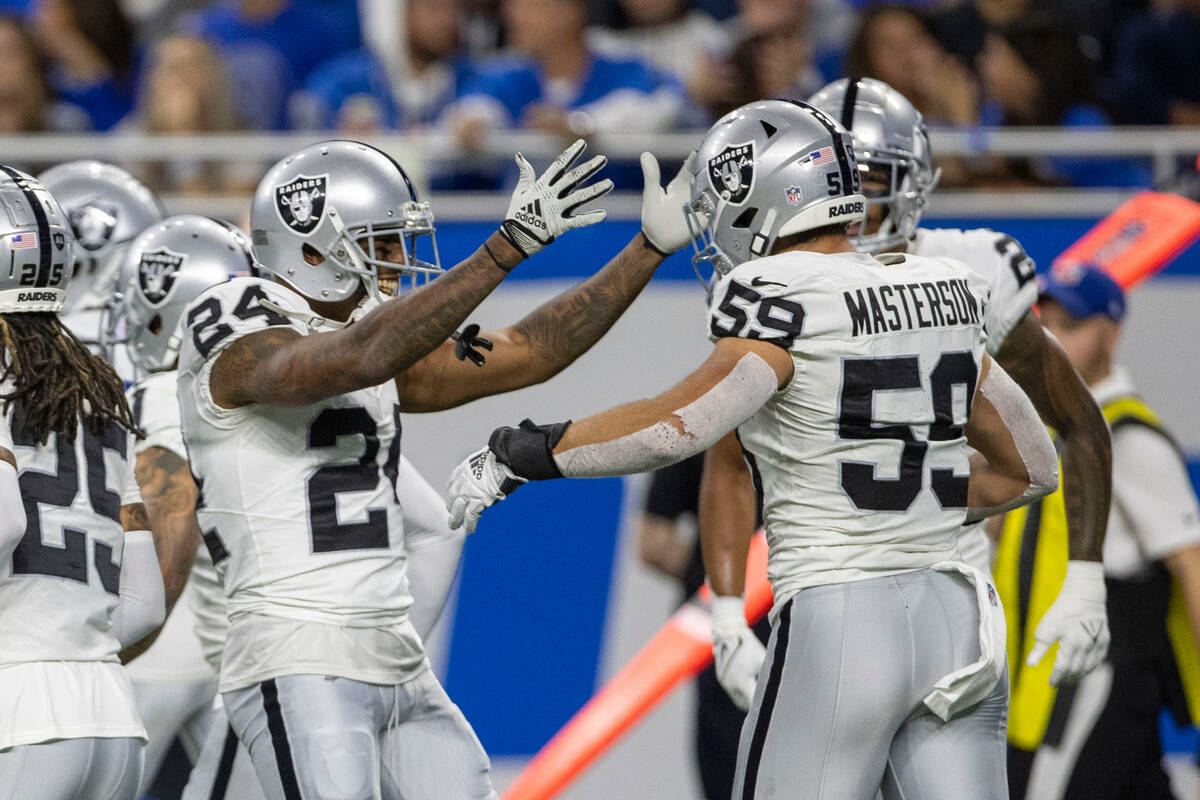 Raiders cornerback Marcus Peters (24) celebrates Raiders linebacker Luke Masterson’s (59 ...