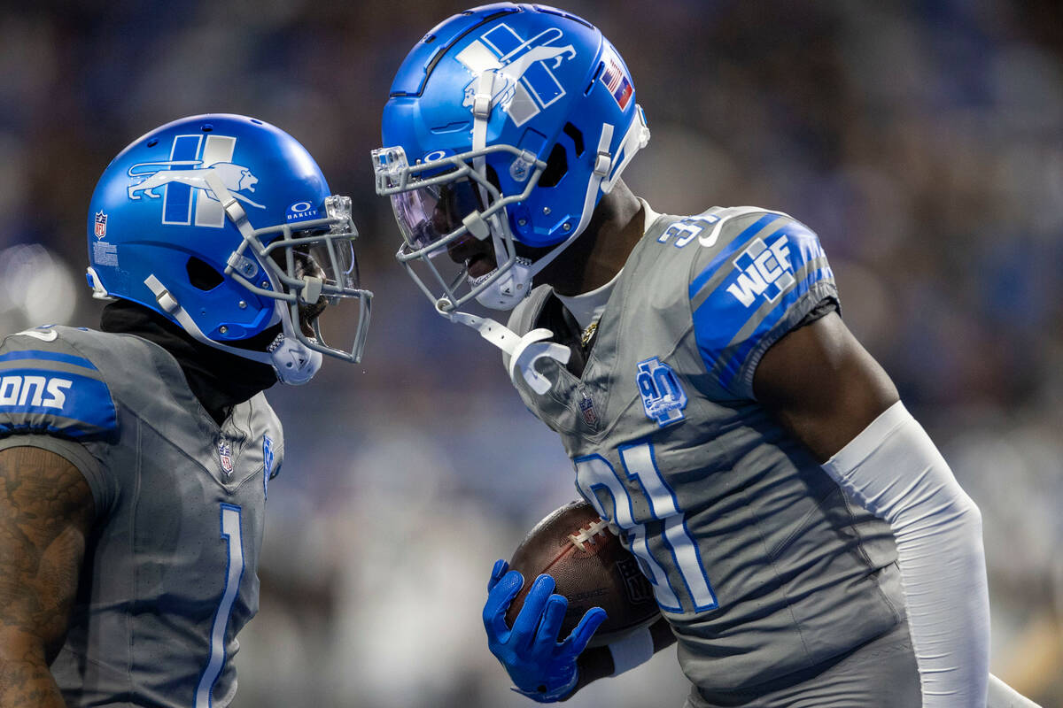 Detroit Lions safety Kerby Joseph (31) celebrates with cornerback Cameron Sutton (1) after int ...