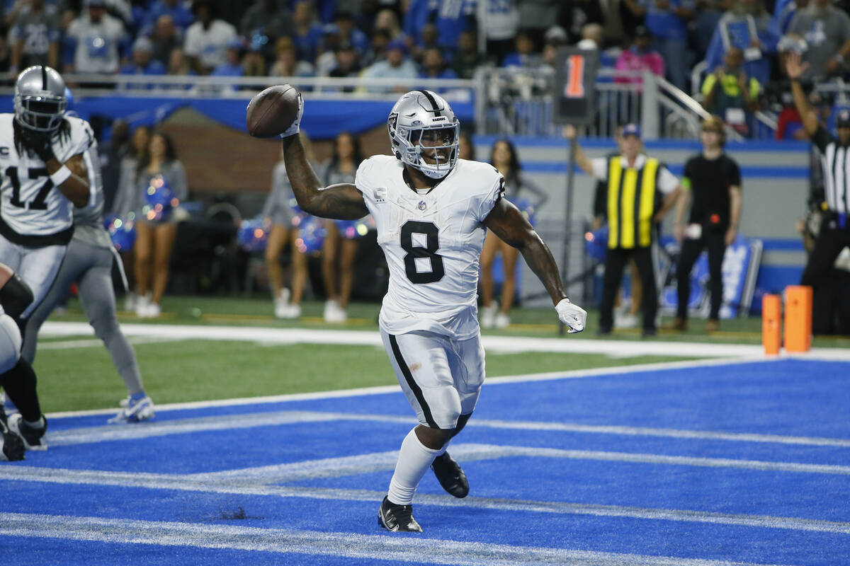 Las Vegas Raiders running back Josh Jacobs (8) throws the ball into the stands afer his three-y ...