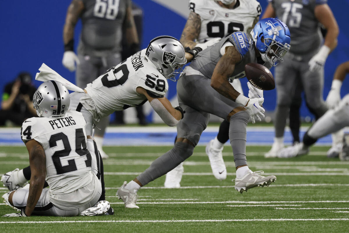 Las Vegas Raiders linebacker Luke Masterson (59) forces a fumble by Detroit Lions wide receiver ...