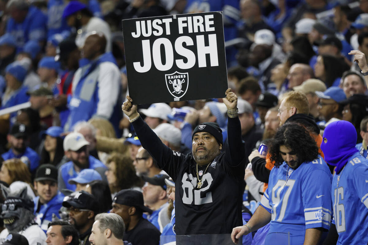 A Las Vegas Raiders fan holds a poster during the second half of an NFL football game against t ...