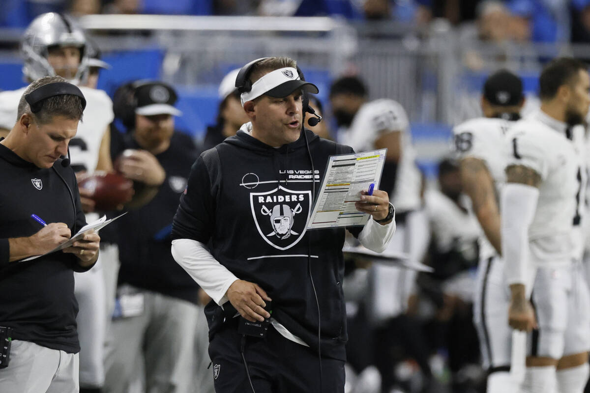 Las Vegas Raiders head coach Joshua McDaniels looks at his play sheet during the first half of ...