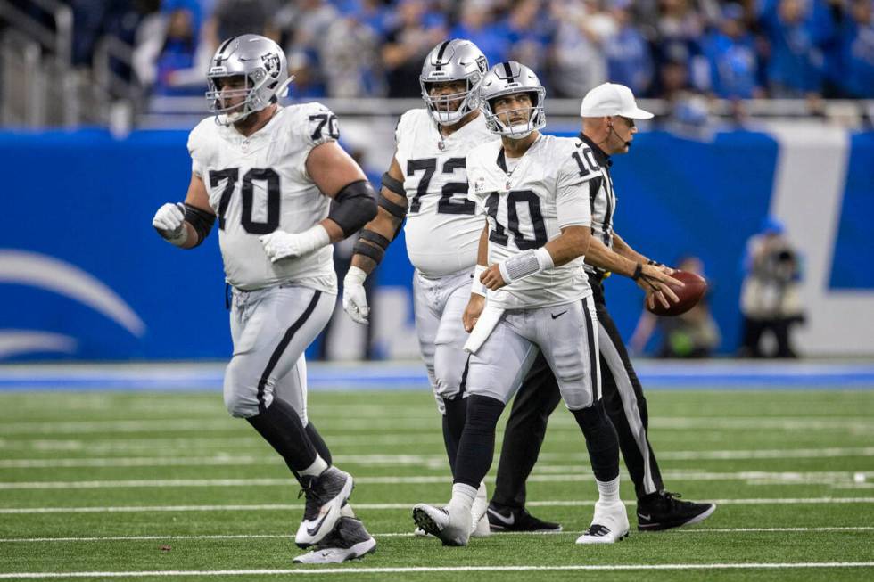 Raiders quarterback Jimmy Garoppolo (10) watches a replay after getting sacked as he comes off ...