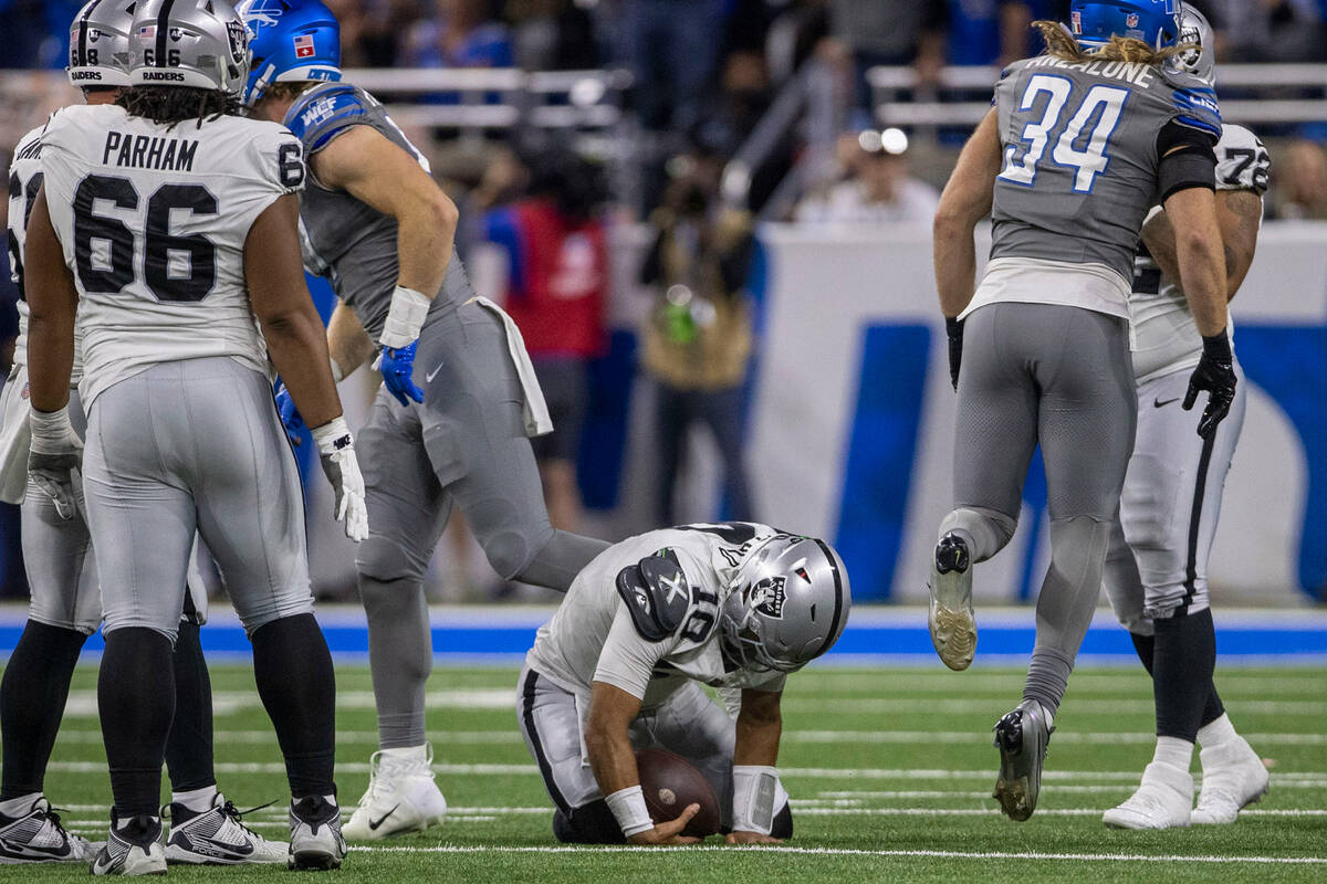 Raiders quarterback Jimmy Garoppolo (10) remains down after being sacked by Detroit Lions lineb ...