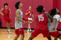 UNLV's men's basketball head coach Kevin Kruger, center, watches his players practice, on Wedne ...