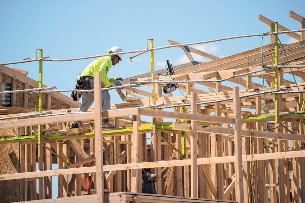 A construction worker helps build a new home in North Las Vegas. A recent report shows new home ...