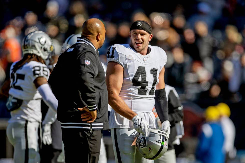 Raiders linebacker Robert Spillane (41) speaks with linebacker coach Antonio Pierce before an N ...