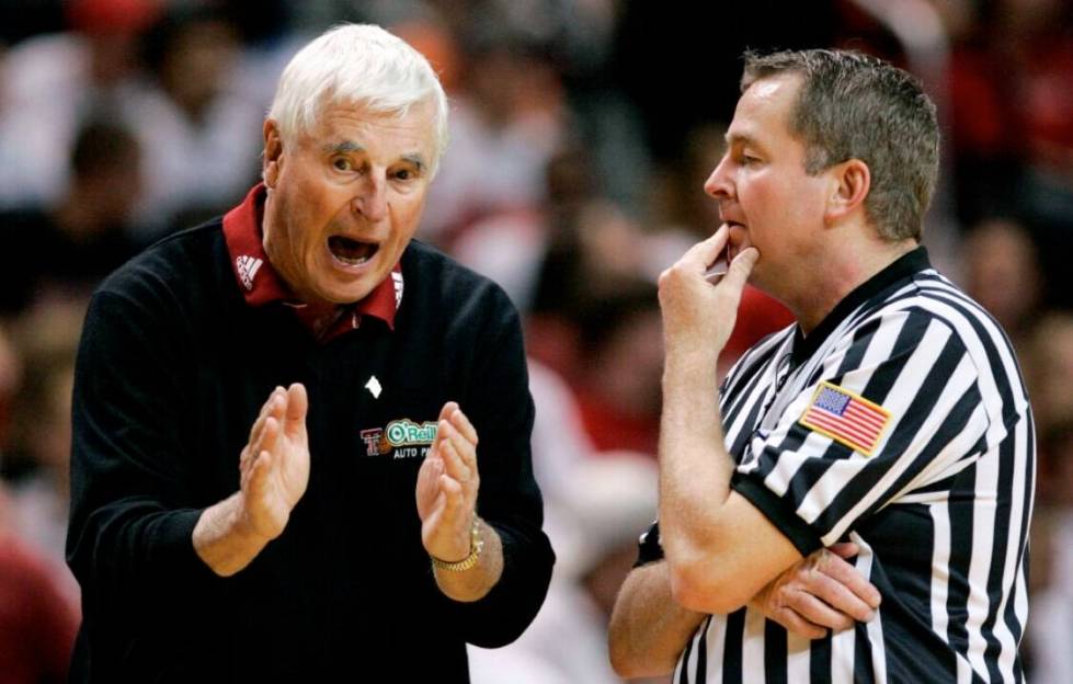 Texas Tech coach Bob Knight, left, argues a call with an NCAA official during a basketball game ...