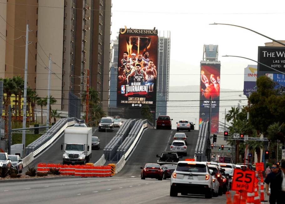 Motorists navigate over the completed temporary Las Vegas Grand Prix Flamingo bridge over Koval ...