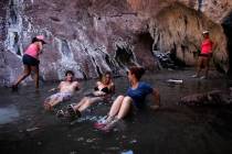 From left, Matt Fields, Gilliane Holt and Brooke Cannon relax in a hot springs pool above Arizo ...