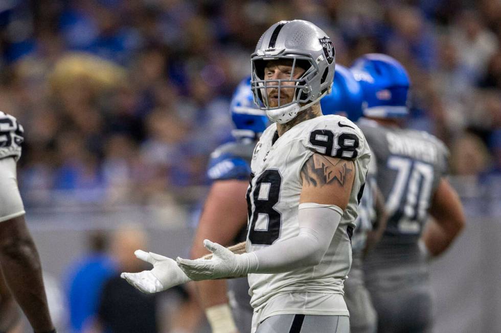 Raiders defensive end Maxx Crosby (98) reacts to being penalized on a fourth down play resultin ...